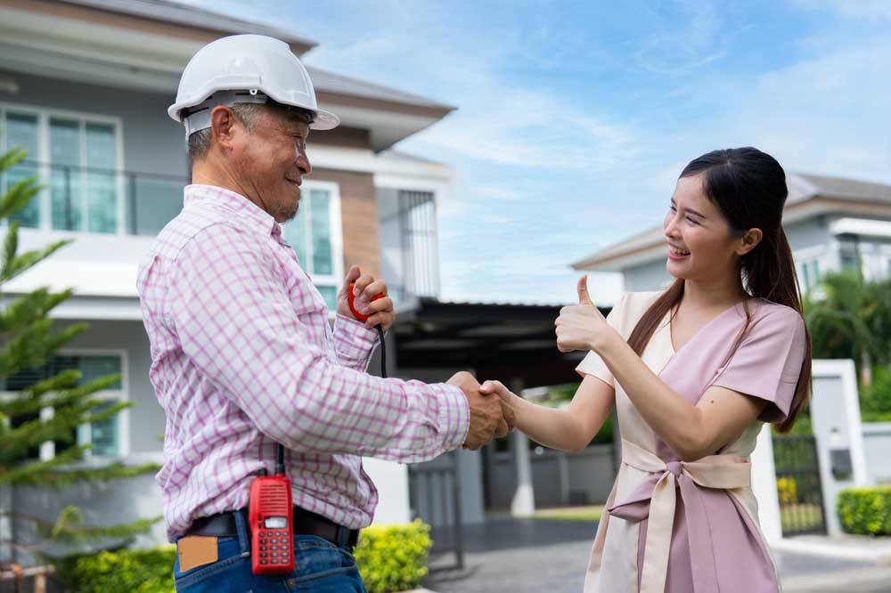 homeowner shaking hands with a plumber