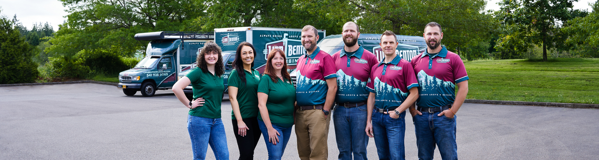 a group of men and women standing together smiling